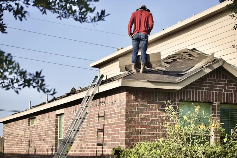 Professional roofer working on a residential roof in Garfield Park East